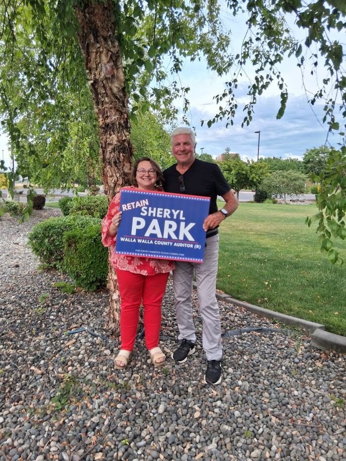Sheryl Park with Washington State Senator Perry Dozier, holding a Retain Sheryl Park yard sign